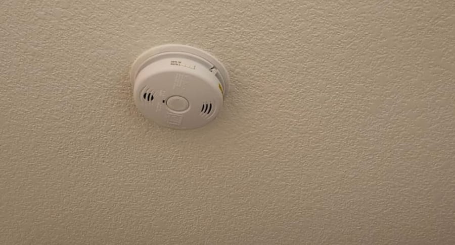A smoke detector installed on the ceiling.