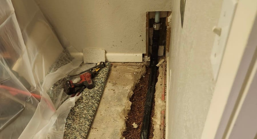 Kitchen plumbing in open floor.