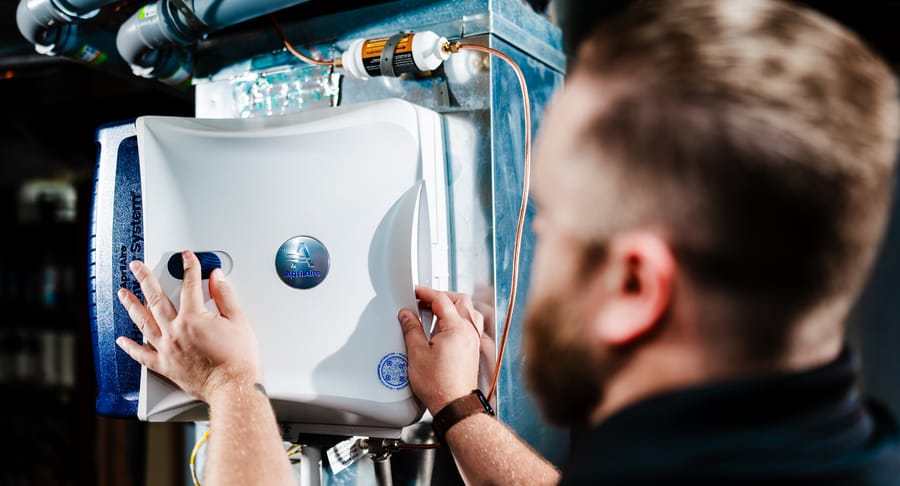 Heart technician installing indoor air quality air purficiation system.