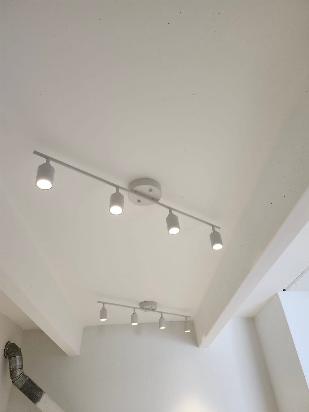 Light fixures installed in a high ceiling.