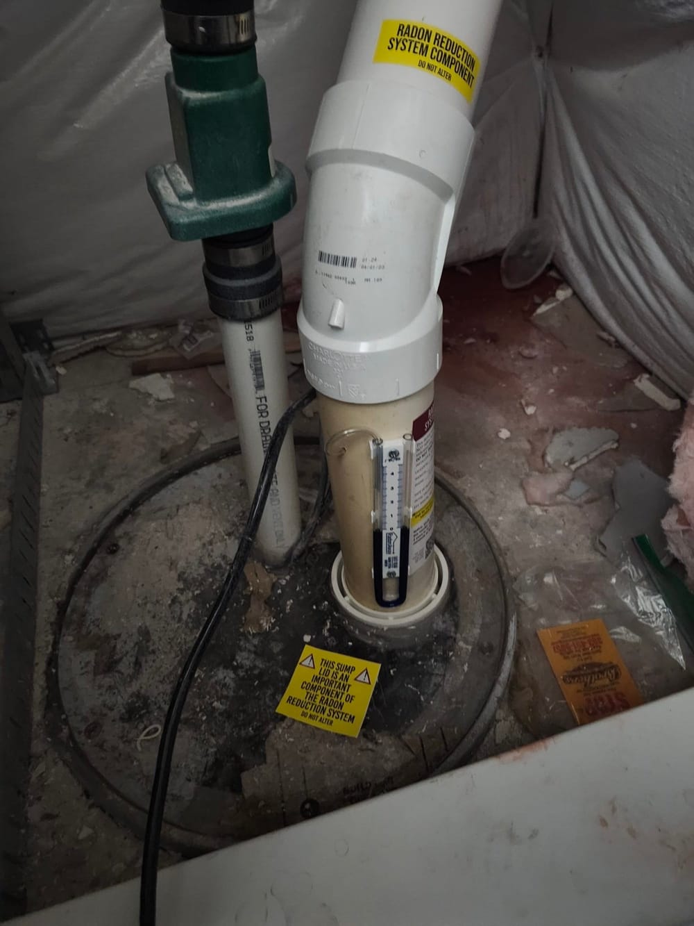 Sump pump in exposed basement floor.